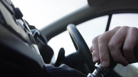 male hand driving van, interior shot. driving with hand on gear stick and change gear