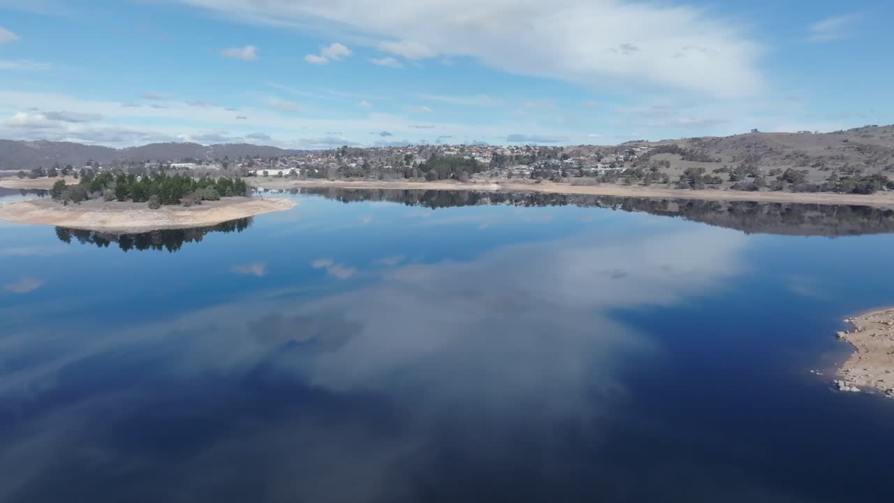 Drone flying over Lake Jindabyne on a clear blue day, NSW, Australia