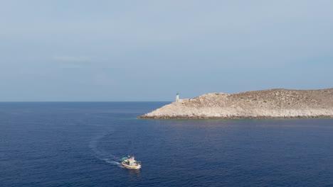 a small fishing boat near cape tainaron lighthouse in the south of peloponnese