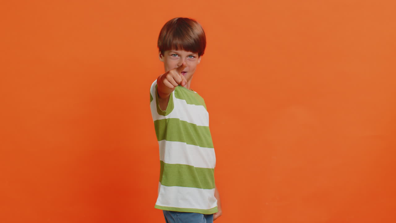 Smiling happy boy pointing forward to camera choosing lucky victory winner indicating promotion