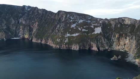 drone video flying around slieve league, ireland at sunset from right to left