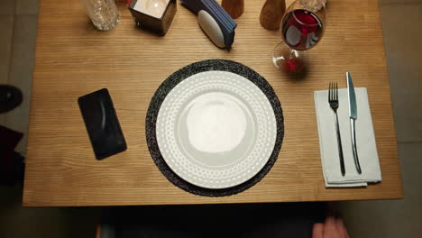 waiter hand putting food plate on fancy restaurant table. delicious dinner plate