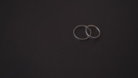 Pair-of-wedding-rings-and-flashing-fire-on-black-background