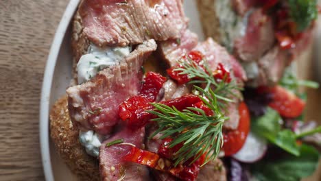 delicious beef steak sandwiches with dried tomatoes and dill