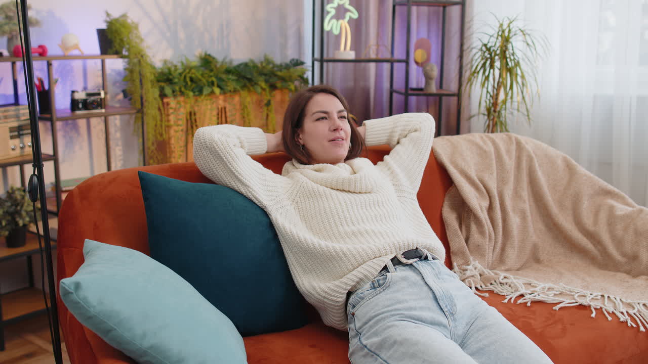 Tired lazy woman enjoy relaxing on home sofa resting napping after hard working day closed her eyes