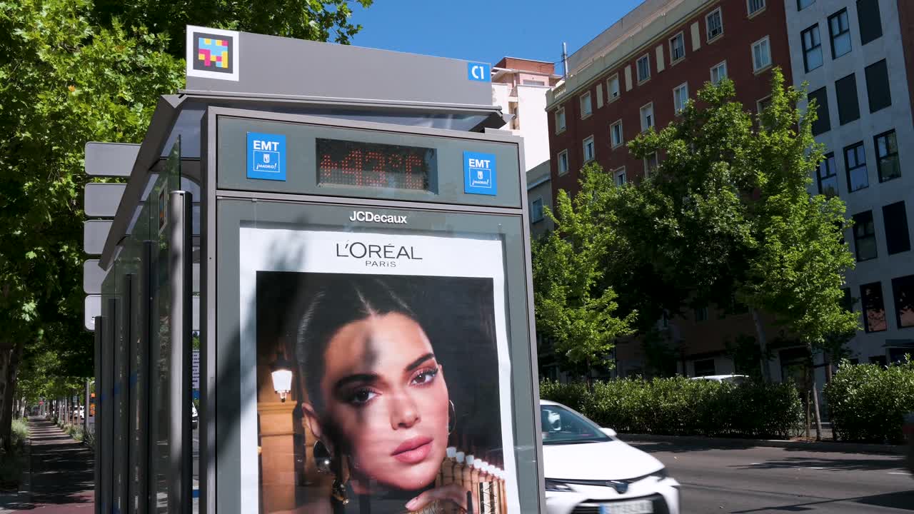Bus stop with L'Oréal advertisement featuring Kendall Jenner in an urban setting