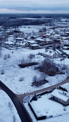 Snowy residential area in Katlakalns, Riga, with quiet streets and houses visible.Vertical shot.