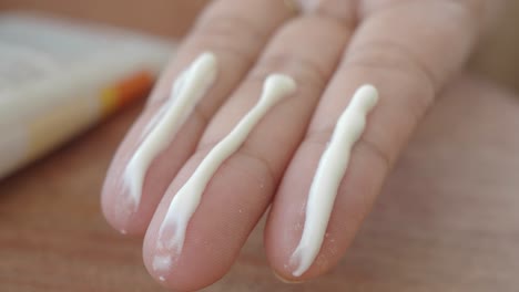 close-up of a hand with sunscreen on it