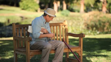 old man getting up from a bench