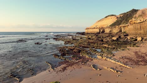 Rugged-stone-and-rocky-formations-adorn-the-backdrop-of-seawater