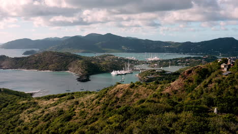 aerial shot of sunset in english harbor in antigua, caribbean with views of yachts, sailboats, marina, bay and cliffs