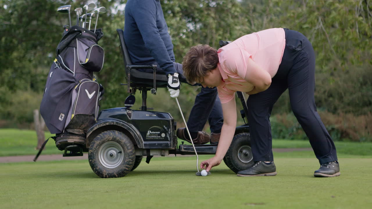 Man playing golf with a mobility golf cart