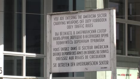 sign near former border crossing checkpoint charlie in berlin, germany