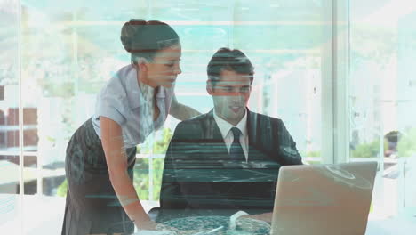 collaborating over digital interface, business professionals in modern office with laptop