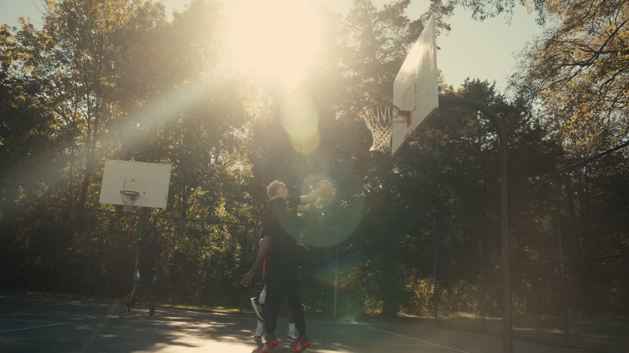 Basketball game on an outdoor court during the day