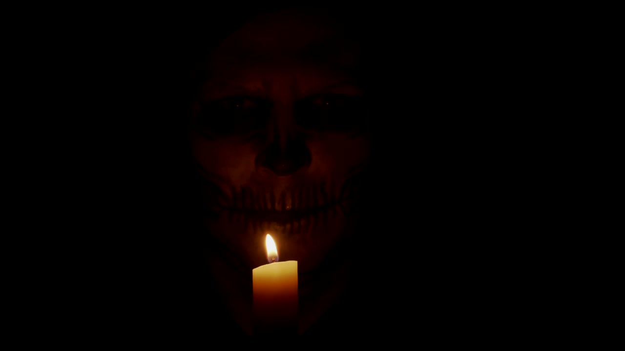 A man with skeletal makeup is looking at the camera.