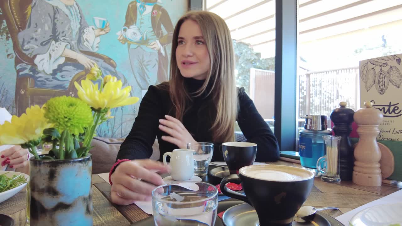 Women talking and drinking coffee at a restaurant