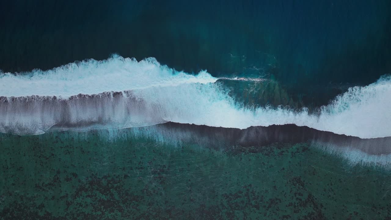 Waves crashing mid colorful aqua turquoise shallow coral reef Teahupoo Tahiti aerial drone birdseye view perspective French Polynesia surf wave Pacific Ocean Channel Point Faremahora Pass Havae static