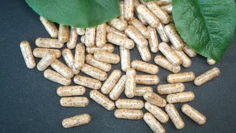 natural herbal capsules with green leaves