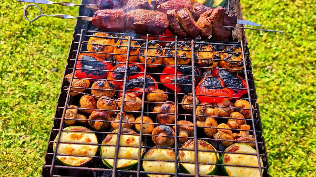 Assorted meat and vegetables cooking on an outdoor BBQ grill, perfect summer meal