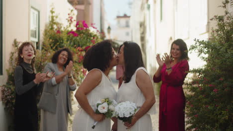 lesbian newlyweds kissing after their wedding ceremony