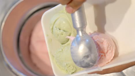 strawberry ice cream in an ice cream parlor being served in an ecological jar