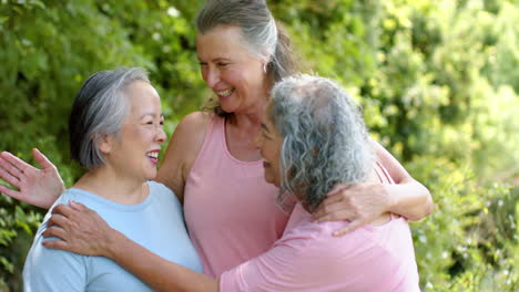 Senior-biracial-woman-enjoys-a-moment-with-Caucasian-and-Asian-women-outdoors