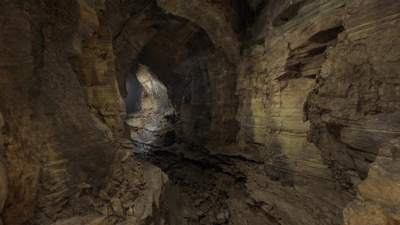 Subterranean passage featuring layered rocks and distant illumination
