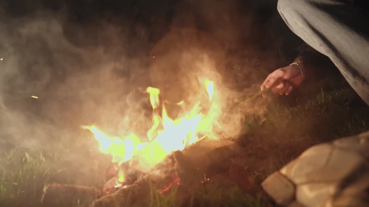 Boy near a campfire at night