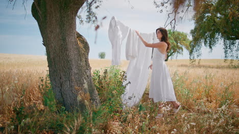 gorgeous model posing country exterior. young woman standing near white linen