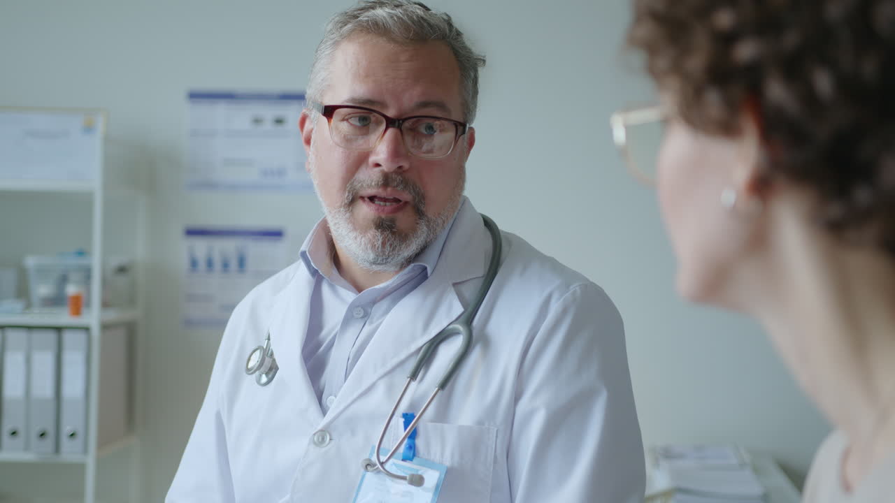 Experienced Doctor Consulting Female Patient Visiting in Clinic