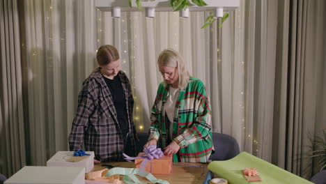 mother and daughter wrapping presents