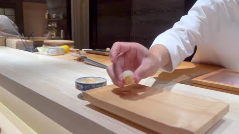 chef prepares sushi with precision and care