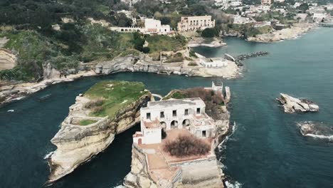 a view from above of the beautiful and small gaiola island , in the nation park of gaiola in naples