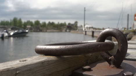 close -up of iron hook detail, in the background a river landscape