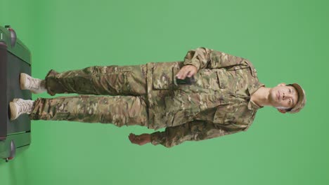 full body of asian man soldier walking and drinking coffee in the green screen background studio