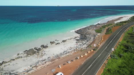 View-of-the-calm,-relaxing-ocean-of-Cape-Leeuwin-Coast-and-empty-road-of-south-Australia-by-drone