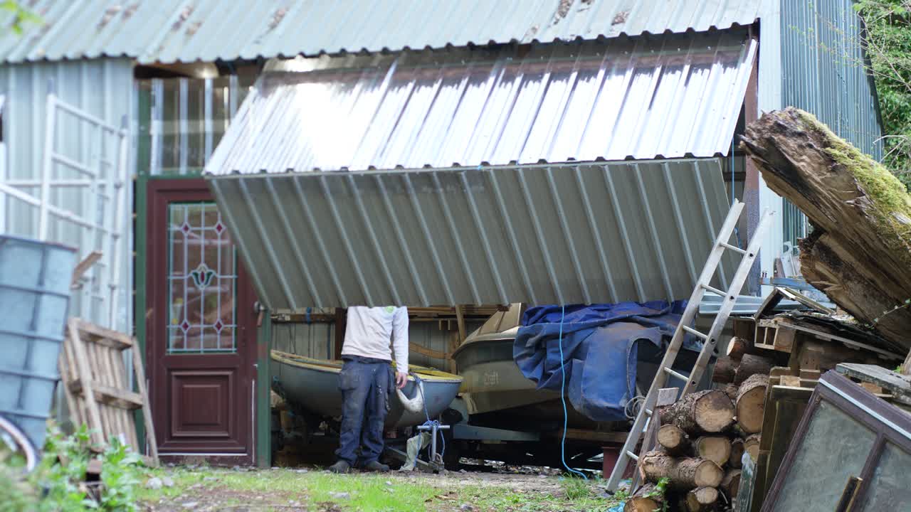 Man Closing Automatic Garage shop door evening