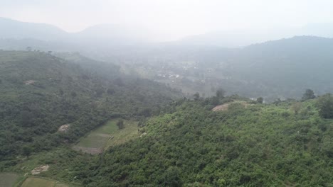 Aerial-Drone-Shot-Of-Plantations-Surrounded-By-Hills