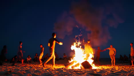 nighttime beach party with bonfire