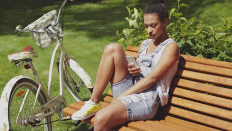 youngster with smartphone and bicycle