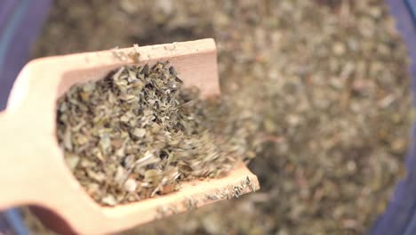 dried herbs being scooped