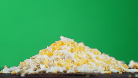 a pile of grated boiled egg slowly rotates.