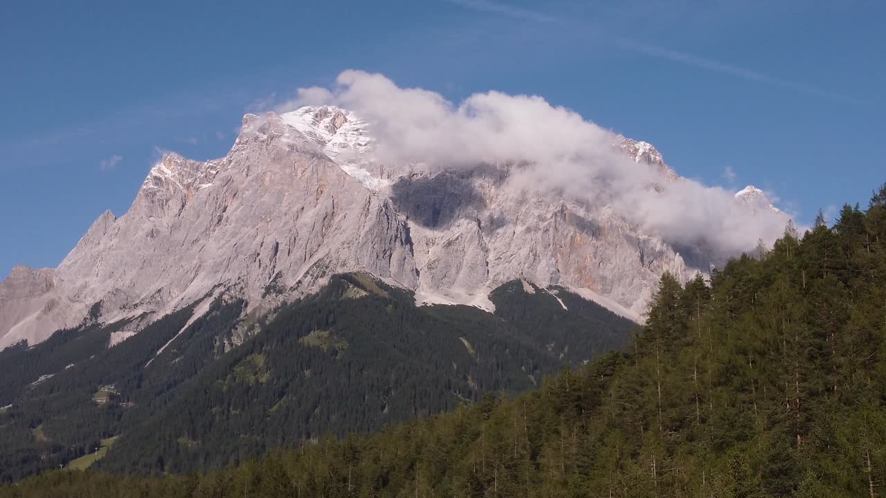 Establishing shot of Germanys highest mountain the Matterhorn in the Alps filmed from Austria in a steady position by a drone