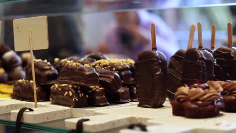 Assorted-sweet-chocolate-candies-on-counter-in-shop