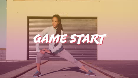 game start text banner against african american fit woman performing stretching exercise outdoors