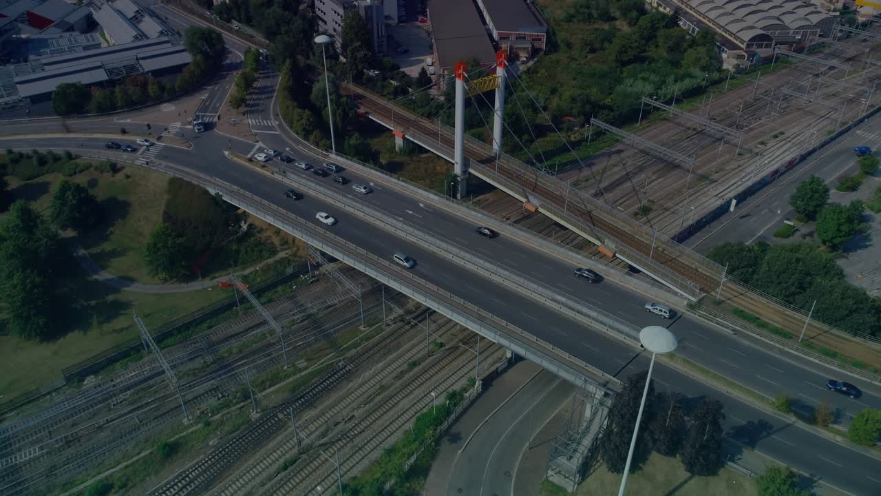 Teal red overlay appearing and sweeping while cars moving across bridge, revealing rail yard flow