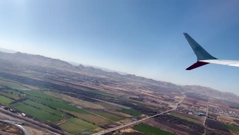 shot of airplane window seat flying over chihuahua mexico