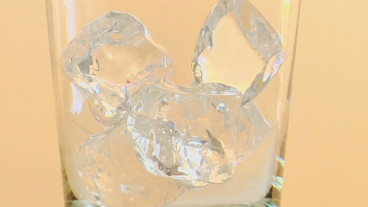 Tilt up to as liquor is poured into a glass with ice