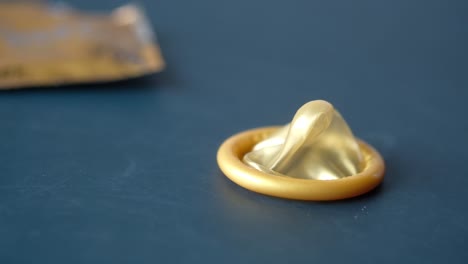 close-up of a rolled gold condom